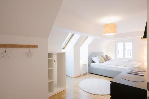 a white living room with a white couch in a room at Cozy Kunsthaus GRAZ in Graz