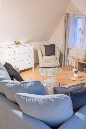 a living room with a couch and a table at Cozy Kunsthaus GRAZ in Graz