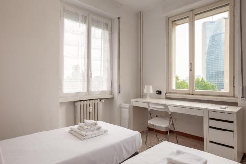Cama o camas de una habitación en Spazioso appartamento - City Life - Fiera Milano - Alcuino 5