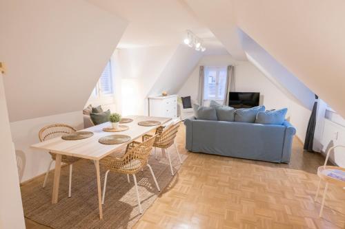 a living room with a table and a couch at Cozy Kunsthaus GRAZ in Graz