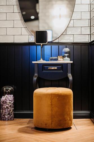 a stool sitting on the floor in front of a mirror at Craves in Brussels