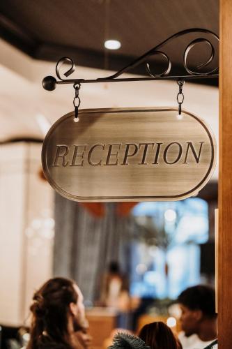 a sign for a restaurant hanging from a wall at Craves in Brussels