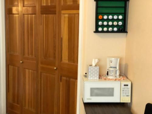 a microwave sitting on a counter next to a door at 1 or 2 bedrooms with bath at Indian Peaks golf course in Lafayette