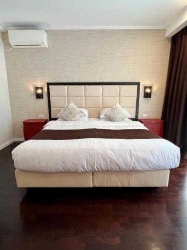 a bedroom with a large bed with white sheets and pillows at Krystal Boutique Mansion in Hunedoara