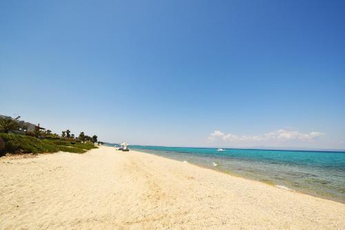 a sandy beach with the ocean in the background at Nena Sea Side Maisonette, Hanioti in Hanioti