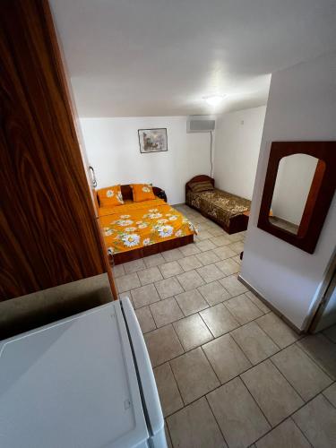 a small room with a bed and a mirror at Casa Anhela in Corbu