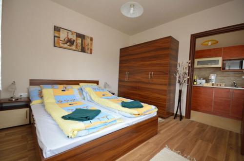 a bedroom with a large bed with towels on it at Hanság Vendégház in Kapuvár