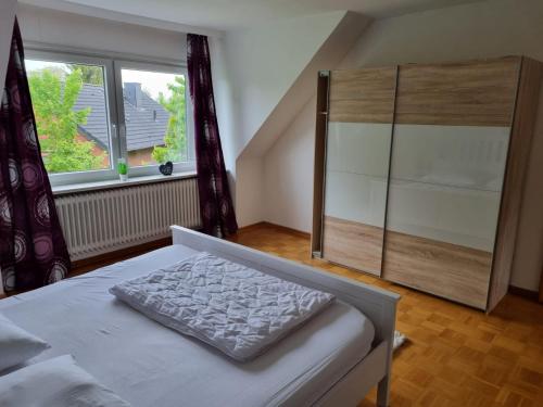 a bedroom with a bed and a large window at Unterkunft in Erholungsort Sterup Nähe von Ostsee in Sterup