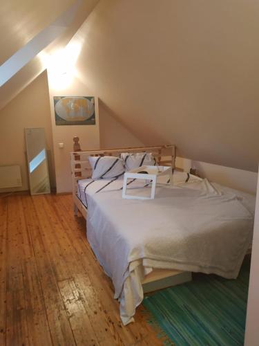 a bedroom with a large bed in a attic at Red Nose roof-top apartment in Rīga
