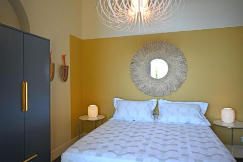 a bedroom with a bed and a mirror on the wall at Villa ALFONSA in Saint-Raphaël