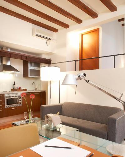 a living room with a couch and a table at Mercer House Bòria BCN in Barcelona