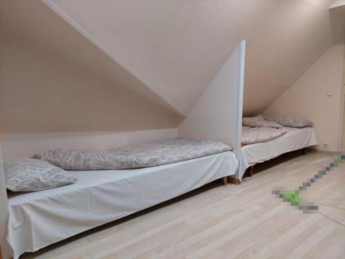 two beds in a room with a attic at Cottages Delloress in Jūrmala