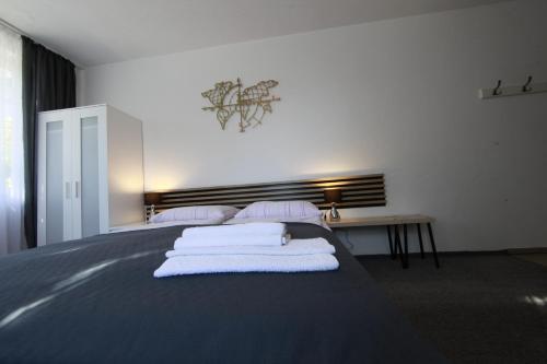 a bedroom with a bed with towels on it at Willa Park Międzyzdroje in Międzyzdroje