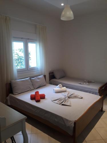 a bedroom with two beds with towels on them at Elena Rooms-Apartments in Asprovalta