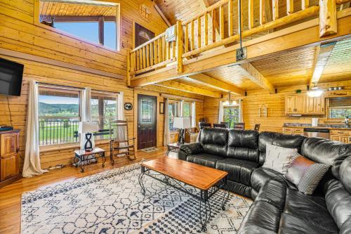a living room with a leather couch and a table at Waterwheel Retreat in Sturgis