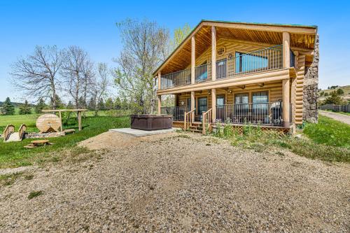 a large house on a dirt road with a yard at Waterwheel Retreat in Sturgis