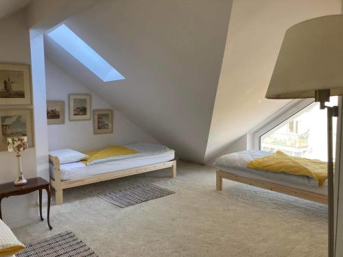 a bedroom with two beds in a attic at Mechechill in Mechelinki