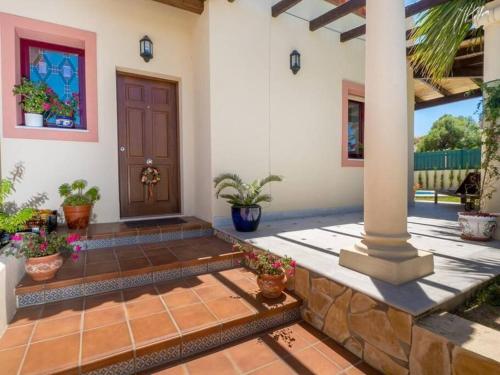 a front door of a house with potted plants at Villa HEIDI in Málaga