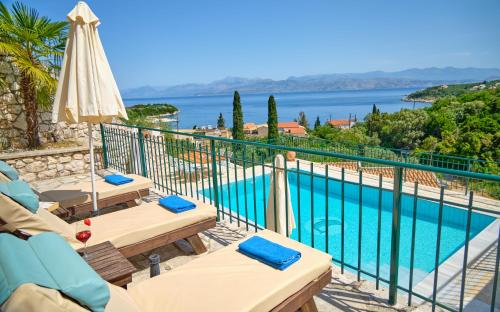 a view from the balcony of a villa with a swimming pool at Villa Spiros Imerolia Kassiopi in Kassiopi