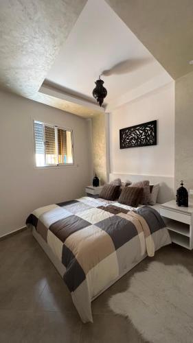 a bedroom with a large bed in a room at Tiwaline Tarsime App B in Sidi Ifni