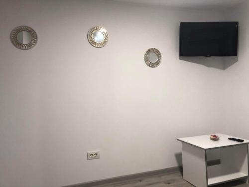 a white wall with two plates and a television on it at Casa Lexi in Mangalia