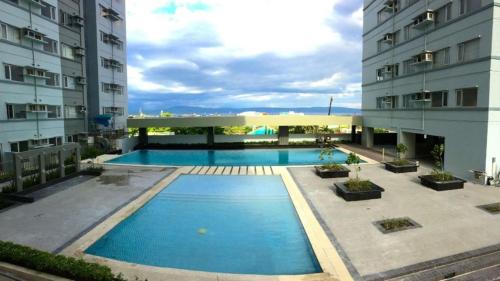 uma piscina no meio de dois edifícios em Avida Tower Furnished Contemporary Studio Unit em Davao