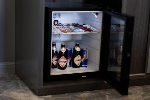 an open refrigerator filled with bottles of beer at WS Hotel in Tabuk