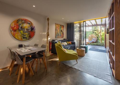 a living room with a table and yellow chairs at Vale de São Torcato Hotel Rural in Guimarães