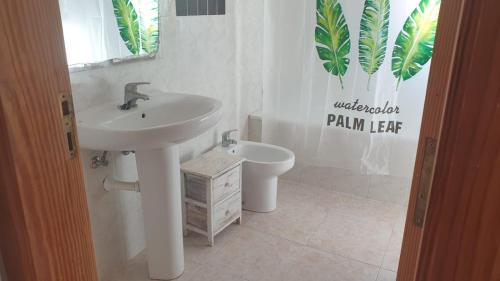 a bathroom with a sink and a toilet at Beach house Cala Morlanda in S'Illot