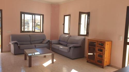a living room with two couches and a coffee table at Beach house Cala Morlanda in S'Illot