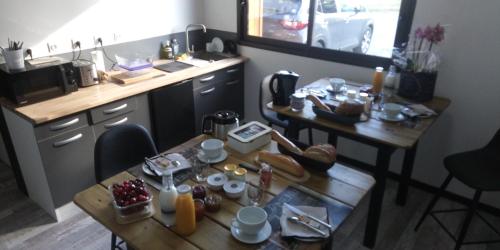 a kitchen with a table with food on it at La chambre du Clos Barriant in Séreilhac