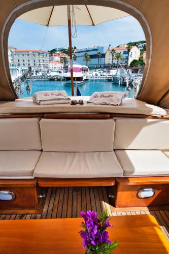 une vue de l'arrière d'un bateau avec une table et des fleurs dans l'établissement La Ornella - Location bateau à quai de Thierry Bourgait, à Banyuls-sur-Mer