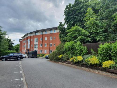 a car parked in front of a brick building at 2 Bed Apartment - Sleeps 5 - Pets - Parking - Wifi in Hatfield
