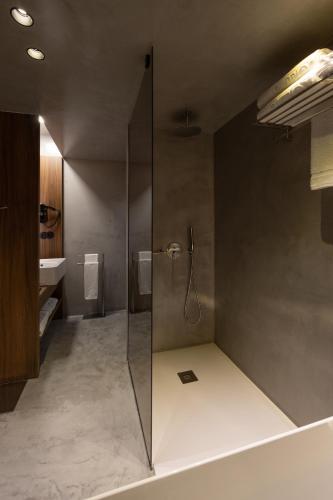 a bathroom with a shower with a glass door at Vale de São Torcato Hotel Rural in Guimarães
