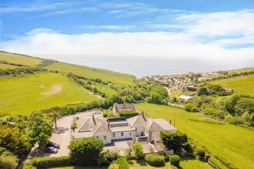 an aerial view of a house in a green field at Eype's Mouth Country Hotel in Bridport