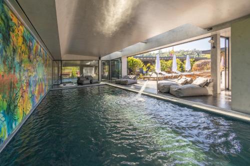 an infinity pool with a water feature in a house at Vale de São Torcato Hotel Rural in Guimarães