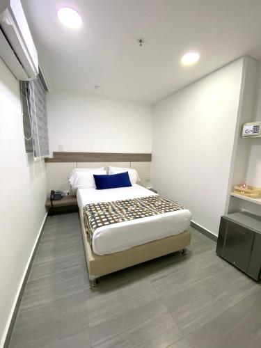 a bedroom with a large bed in a room at Seven Inn Hotel in Medellín