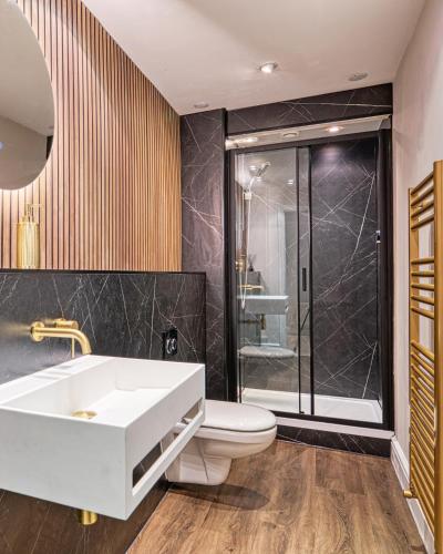 a bathroom with a sink and a toilet and a shower at Luxury Georgian Townhouse with Cinema and parking in Chester