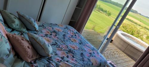 a room with a couch and a sliding glass door at Villa repos in Neuilly-lʼHôpital