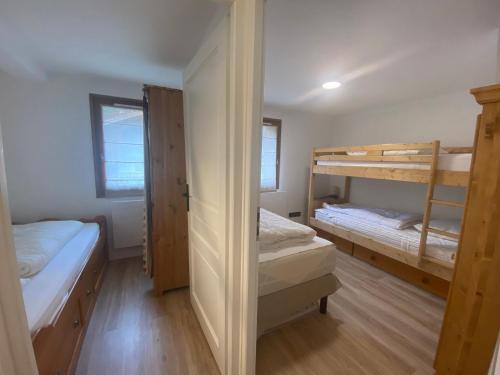 a bedroom with two bunk beds and a closet at Appartement La Clusaz, 4 pièces, 7 personnes - FR-1-437-45 in La Clusaz