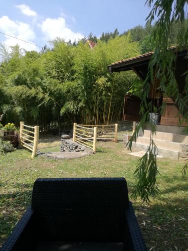a bench in a yard with a wooden fence at Brvnara Aleksic in Kraljevo