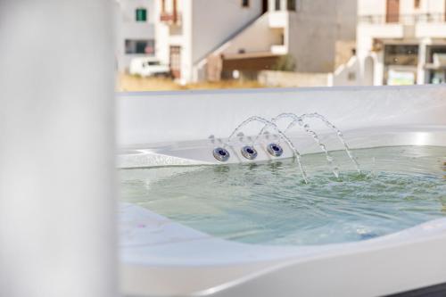 a bath tub filled with water with eyeballs in it at Alenor City Hotel in Naxos Chora