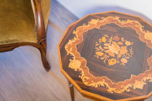 a wooden table sitting next to a chair at Relais Borgo Segine in Melendugno