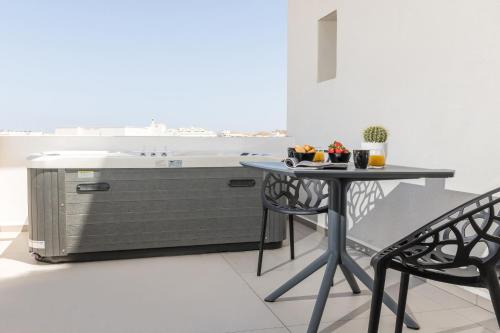 a kitchen with a table and a sink at Alenor City Hotel in Naxos Chora