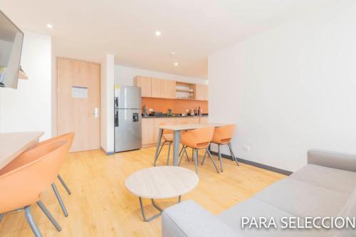 a kitchen and a living room with a table and chairs at CentralX 21 Bogotá in Bogotá