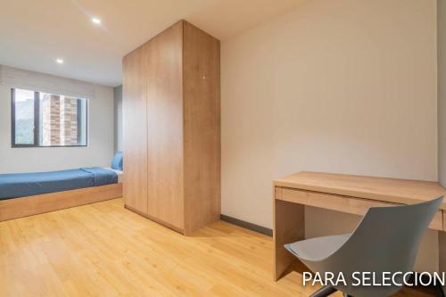 a room with a desk and a bed in it at CentralX 21 Bogotá in Bogotá