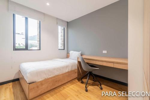 a bedroom with a bed and a desk and a chair at CentralX 21 Bogotá in Bogotá