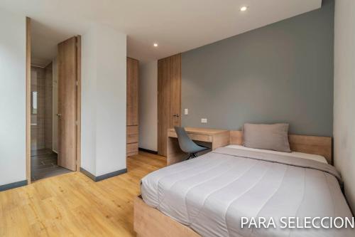 a bedroom with a bed and a desk at CentralX 21 Bogotá in Bogotá