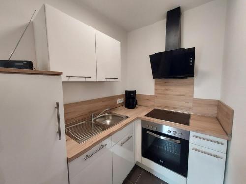 a small kitchen with a sink and a stove at Ferienhaus Zum Prinzenkopf in Alf