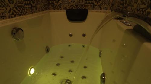 a bathroom with a tub with a shower at Cozy Rooms - BAÑERA HIDROMASAJE in Valencia